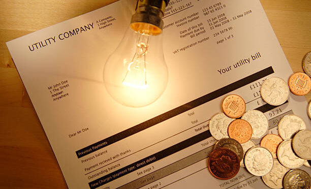 utility bill with lightbulb and coins